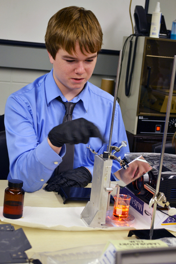 Danville Lutheran middle school student makes an adjustment while printing a 3D image.